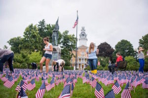 Students walk through flags from a previous 9/11 memorial. (Photo: Courtesy / Hillsdale Collegian)
