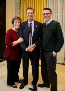 Professor of Accounting Michael Sweeney stands with this wife, Susan, and son, Mike, while holding his Teaching Excellence Award from the Michigan Association of Certified Public Accountant at the banquet that honored him at the Shenandoah Country Club in West Bloomfield on Oct. 5. Michael Sweeney | Courtesy 