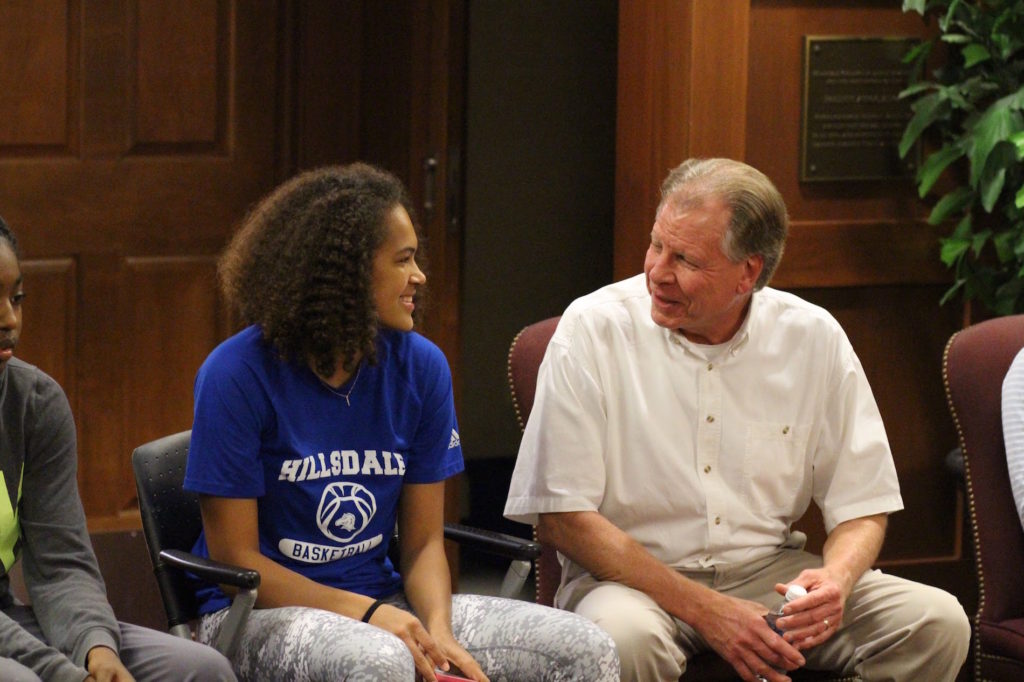 Freshman basketball player Bree Potter and senior InterVarsity Fellowship USA staff member Denny Brogan talk at the beginning of Tuesday's Athletes InterVarsity meeting. Evan Carter | Collegian 