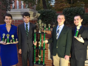 Junior Mary Blendermann, freshman Nathanial Turtel, sophomore Peter Seeley, and junior Steven Custer hold the individual events team's trophies at Marshall University. Matthew Warner | Courtesy 