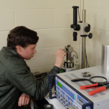 Sophomore Ramette adjusts atomic force microscope