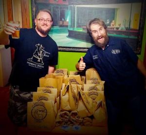 Ramshackle co-foundersJoe Kesselring and  Zach Bigelow with a beer and gifts for donors for their new brewing company,              which they hope to open in the spring of 2016.  Ramshackle Brewing Co.  | Courtesy