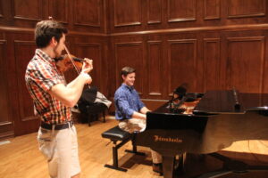 Senior Taylor Flowers collaborates with junior Stevan Lukich. Flowers plans to pursue a career in collaborative music after gradution. Kaylee McGhee | Collegian