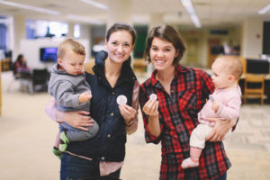 Betsy Howard and Laura Kern founded the Wandeling Press, a publishing house through which they’re publishing their first book, “Woolies for Winter.” Here, each with her child, they hold “Wandeling” buttons. Sarah Gerber | Courtesy