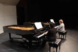 Teacher of Piano Debbi Wyse and friend Kristi Gautsche rehearse in Markel Auditorium. They perform this Friday and Saturday at 8 p.m. Anders Hagstrom | Collegian 
