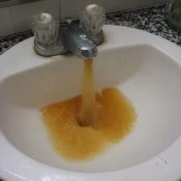 Yellow water pours from a faucet in the Alpha Tau Omega house (courtesy Denton Williams)