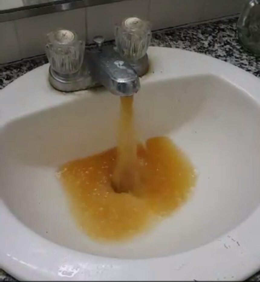 Yellow water pours from a faucet in the Alpha Tau Omega house (courtesy Denton Williams)