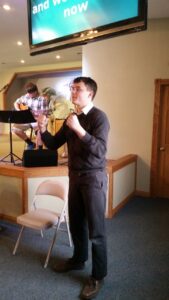 Senior Daniel Slonim practices sign language at the Pine Ridge Bible Church. 
