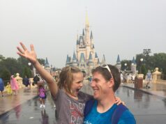 Michael Clark and his daughter smile during a rainy day at Disney World. Courtesy | Michael Clark