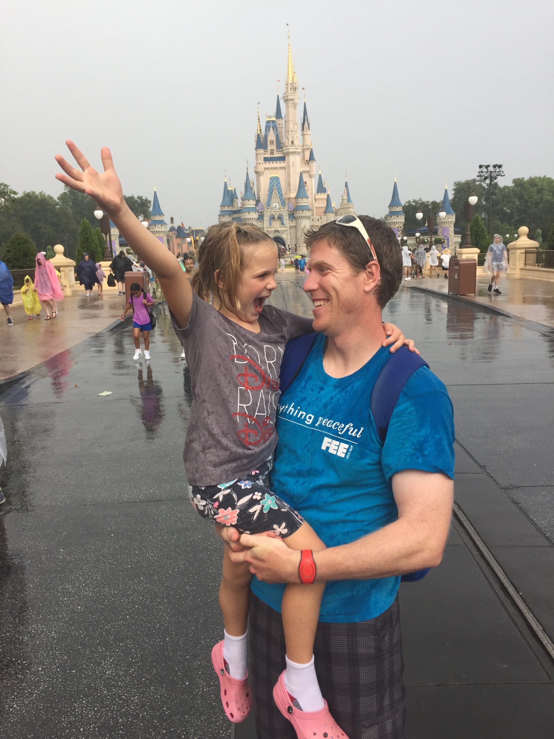 Michael Clark and his daughter smile during a rainy day at Disney World. Courtesy | Michael Clark