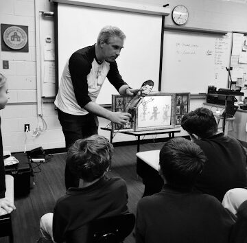 Professor performs with shadow puppets
