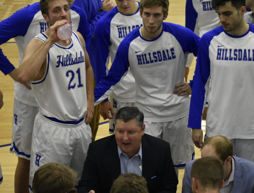 Former Hillsdale basketball head coach John Tharp instructing the team during a time out.