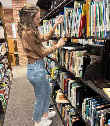 Shelf readers organize books in Mossey