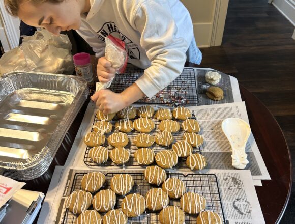 Students exchange textbooks for oven mitts in preparation for Maker’s Market